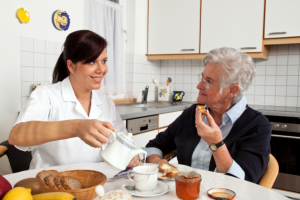 caregiver preparing meal for her patient